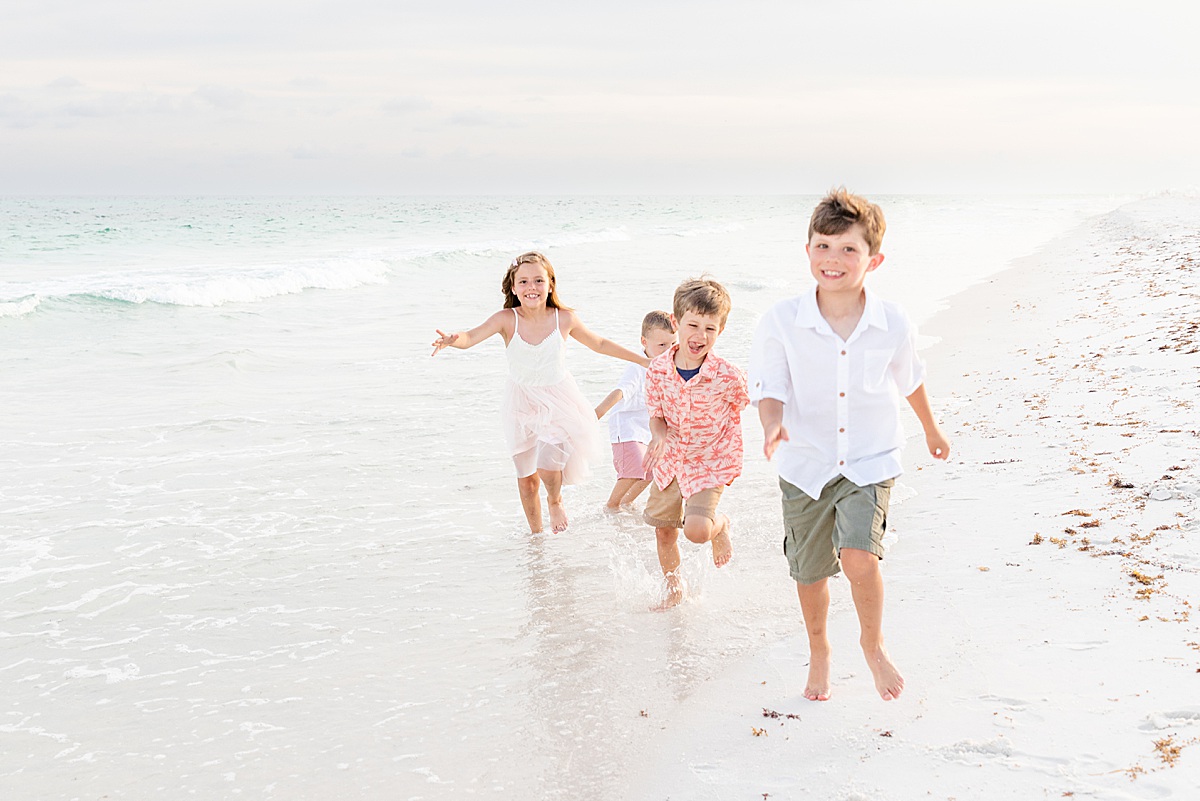 Kids running on the beach by the water | Pensacola Beach extended family session by Pensacola Florida photographer Hannah Hillis Photography