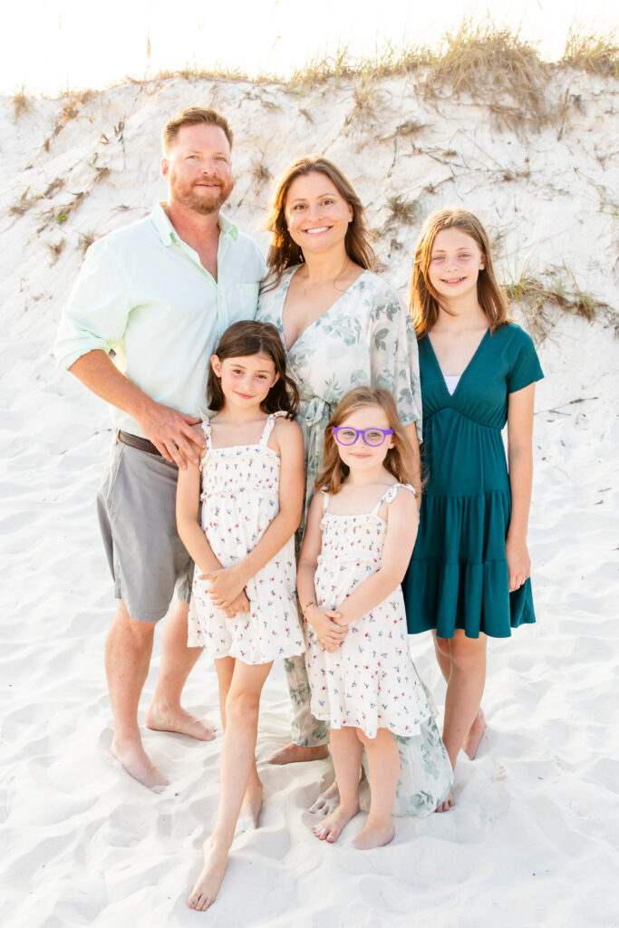 family posing on Pensacola beach during extended family session