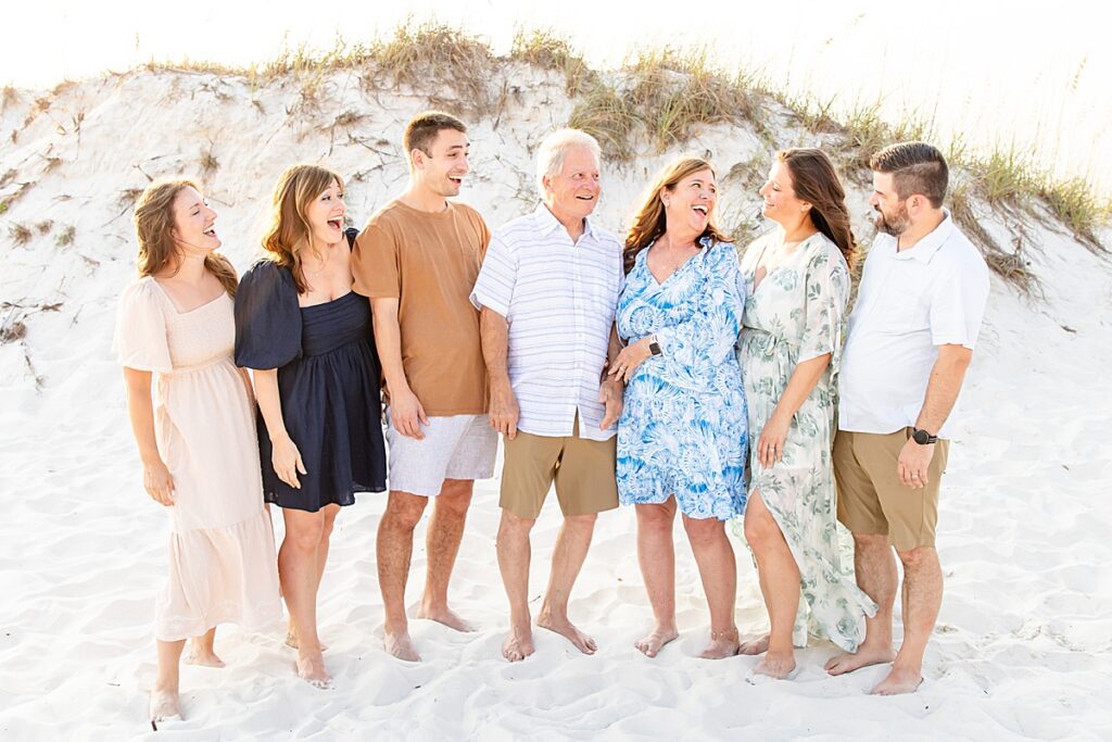 family laughing at each other on pensacola beach during extended family session