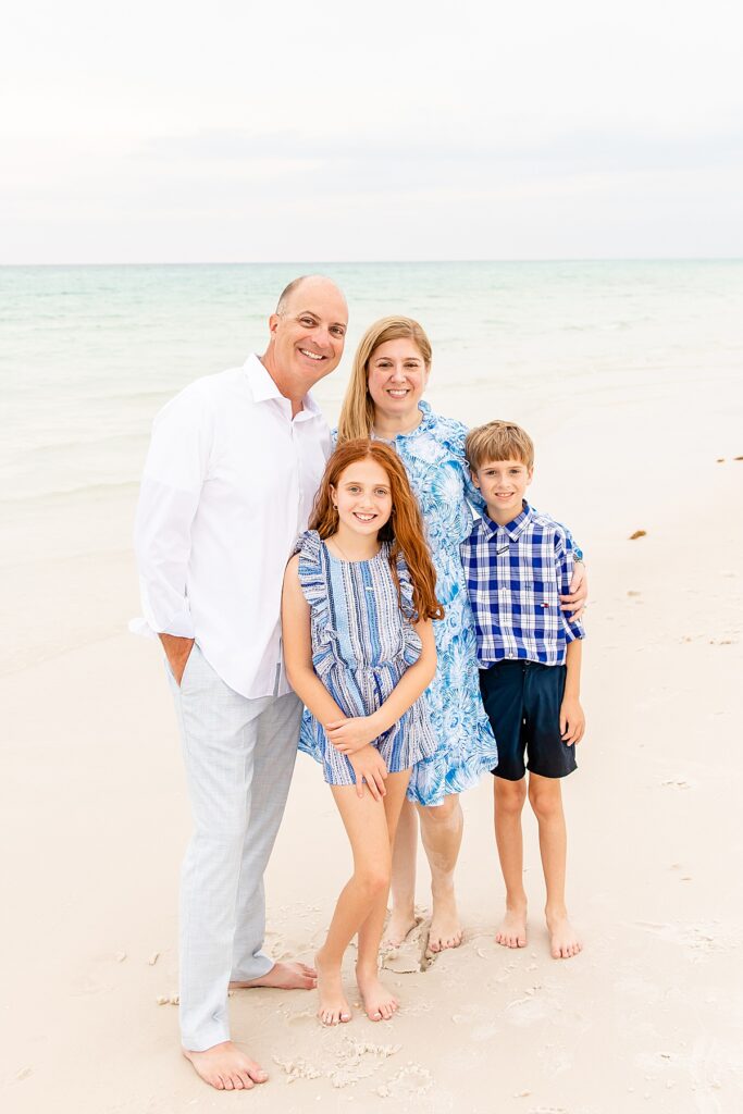 family by the water during family session on pensacola beach