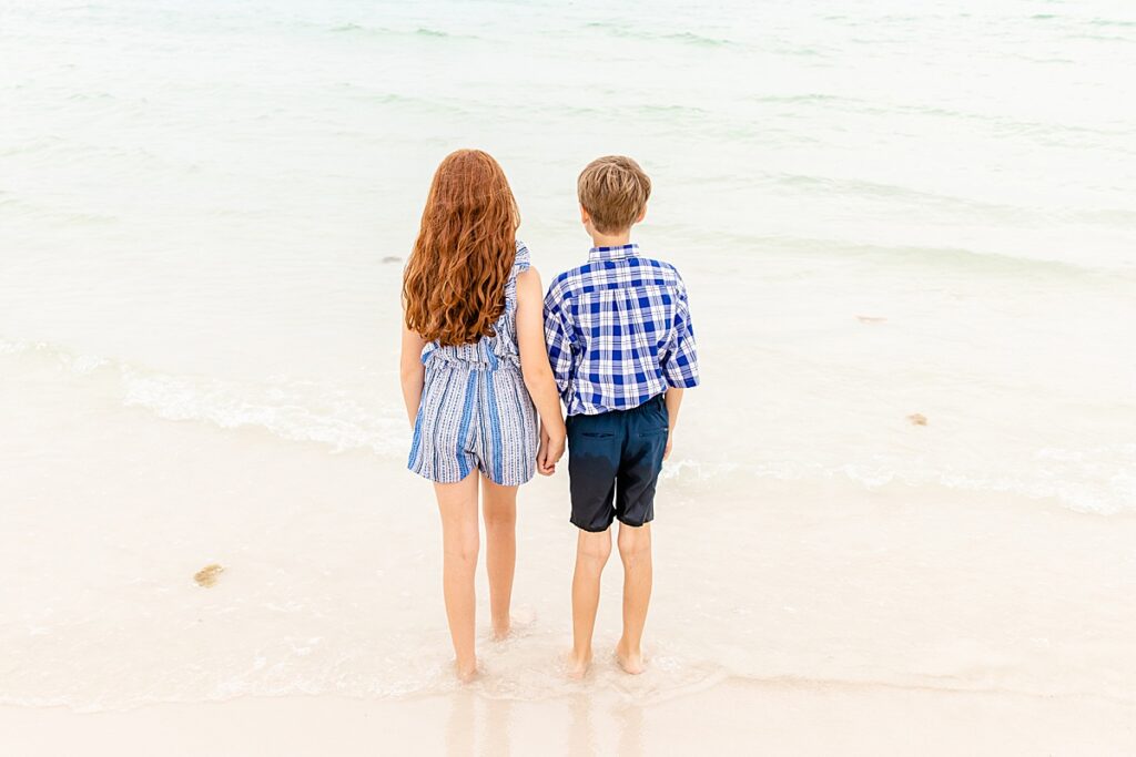 kids looking out at the water on pensacola beach during family session