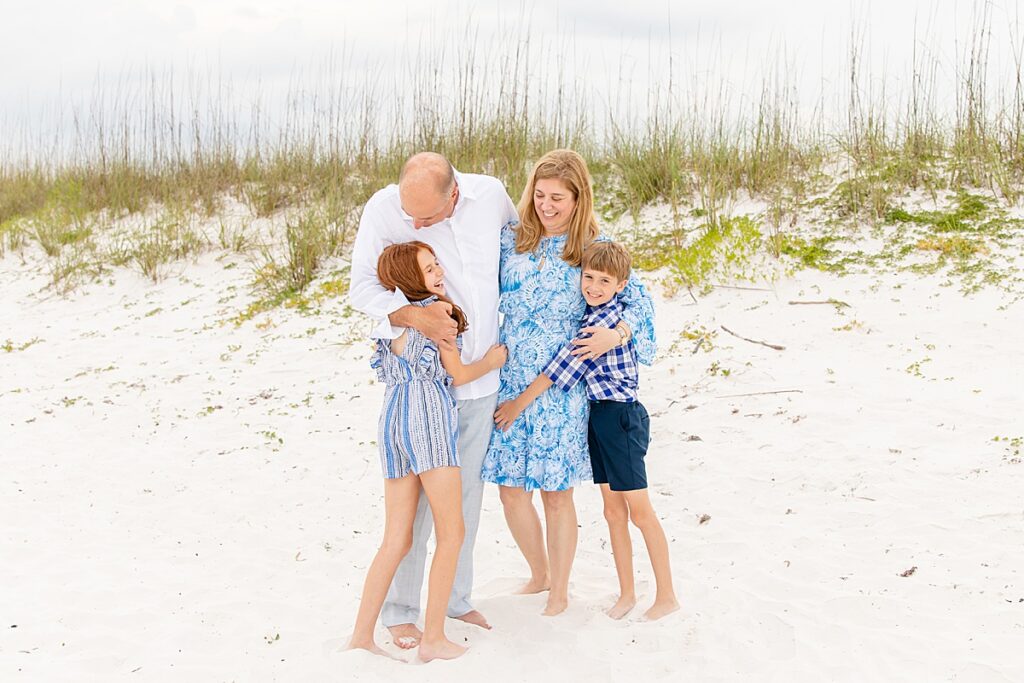 family laughing at each other during family session on pensacola beach