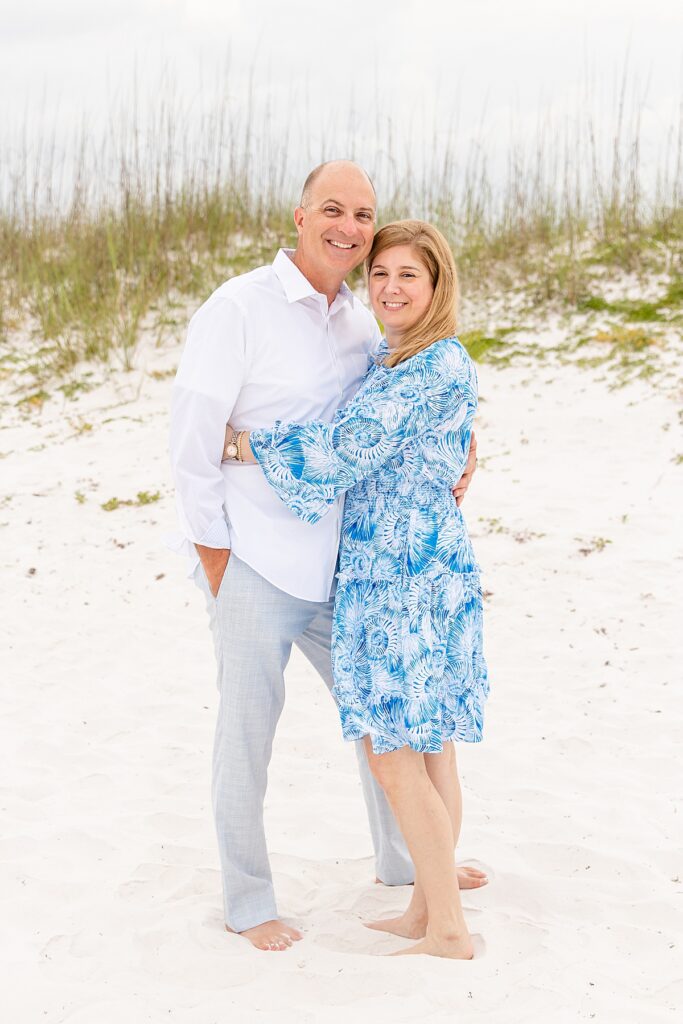 couple posing on the beach during family session
