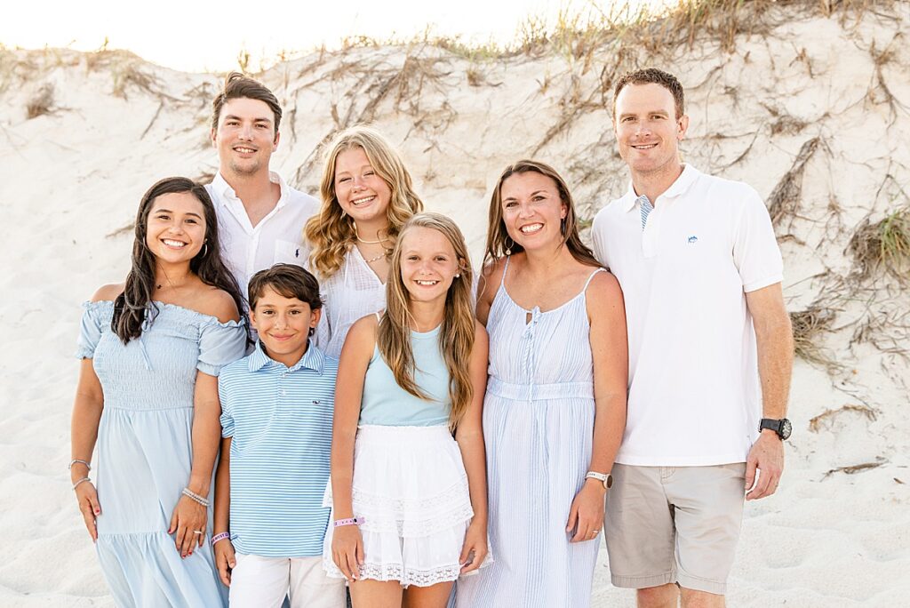 Young family posing on the beach in Gulf Shores, Alabama