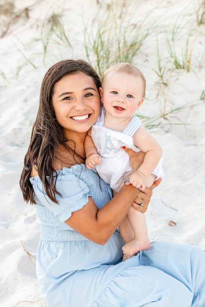 Mom with baby sitting in the sand