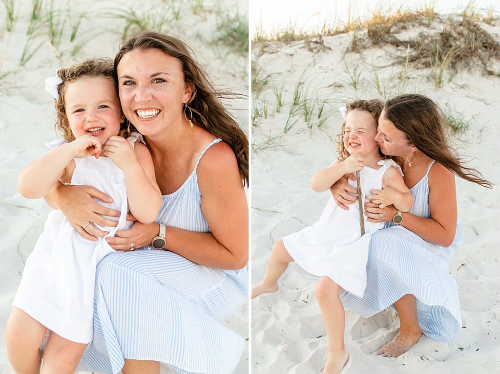 Mom with young daughter sitting in the sand in Gulf Shores, Alabama